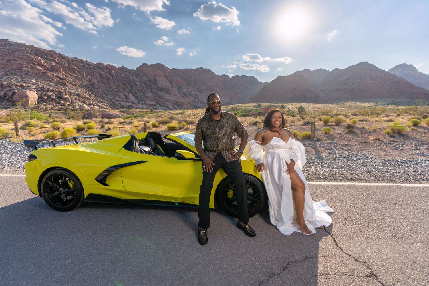 Couple with a yellow Corvette on a desert road