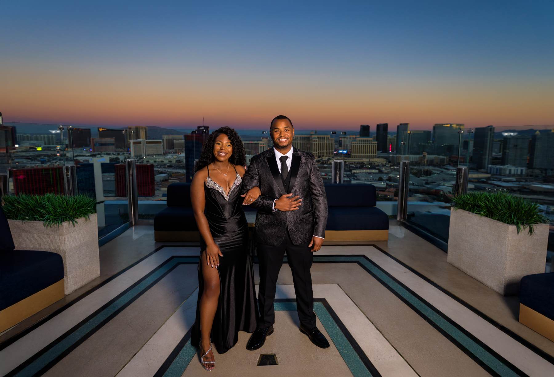 Couple on a rooftop above the Strip at dusk